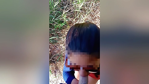 Outdoor brunette in a black tee and dress is standing