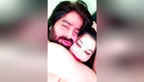 Amateur brunette in a white tank top and black shorts