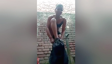 A hot brunette fingerings her tiny breasts outdoors