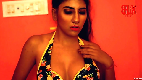 Sexy brunette is posing for the camera in her dressing room