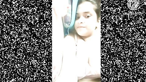 Solo girl in a black dress is on a beach and she is wearing a hat