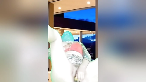 Indian stepmom masturbates on her bed with a big dildo