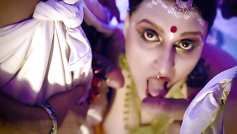 Indian brunette fucks two big cocks on a big table